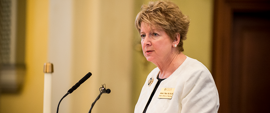 Dean Kathleen Wisser speaks into a microphone