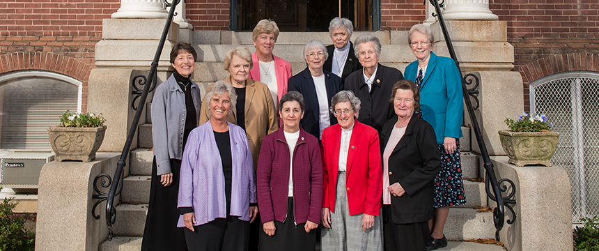 Group photo of current 11 School Sisters of Notre Dame on the stairs