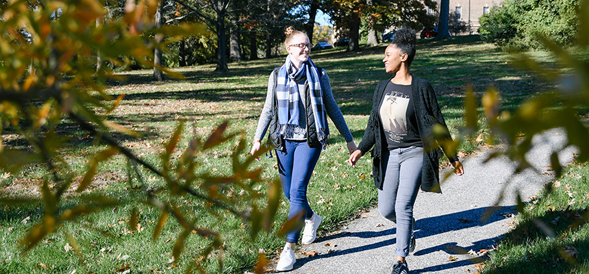 two students walking through campus