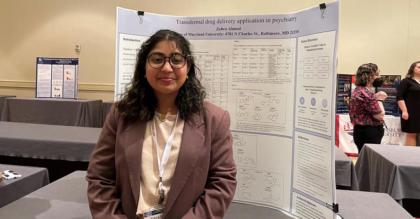 Zohra Ahmed poses in front of her research