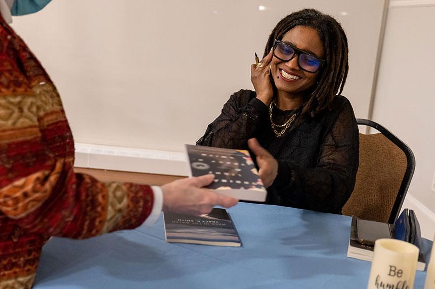 two women near round table smiling