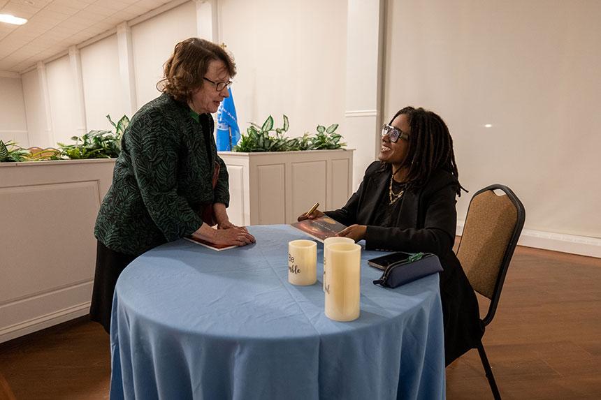 two women near round table talking