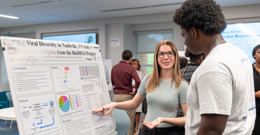 Female student presents poster to a male students
