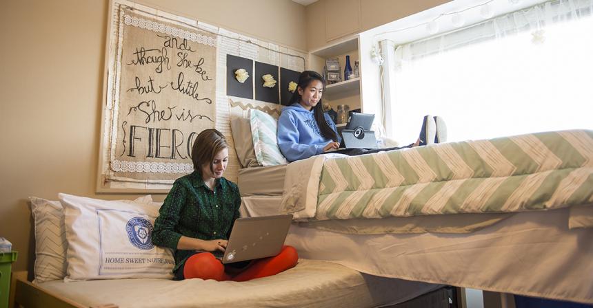students sitting in dorm room