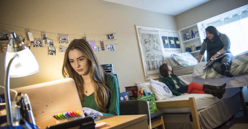 students sitting in dorm room