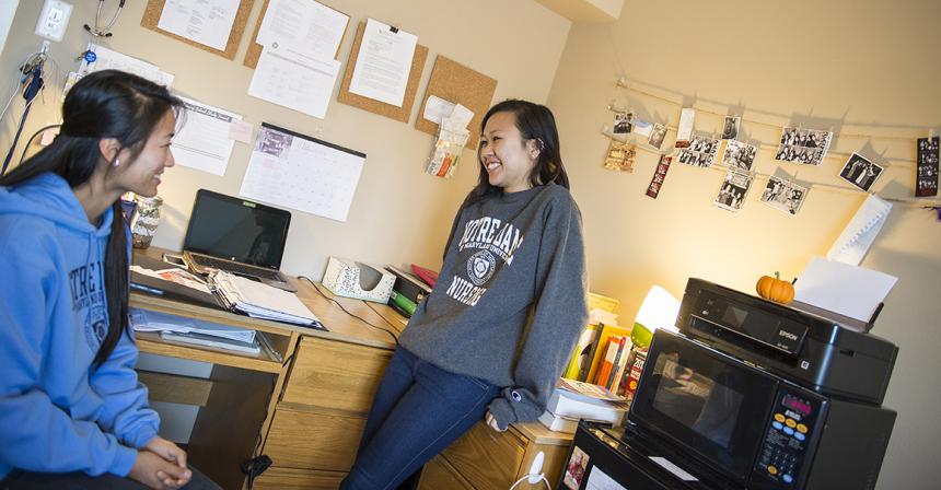 students sitting in dorm room