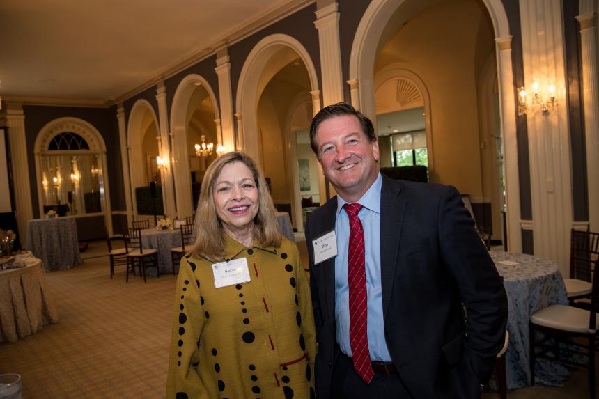 Two guests smile at President's Reception