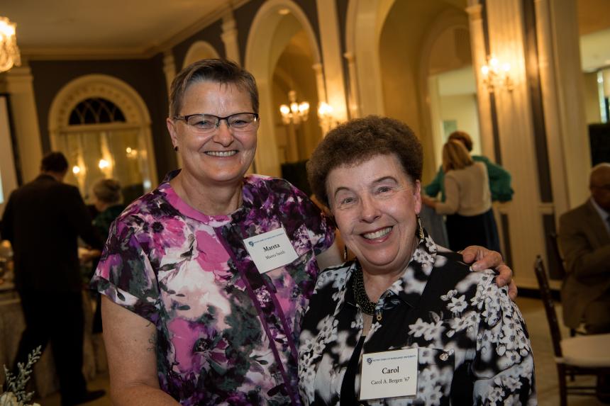 Two women smile for the camera