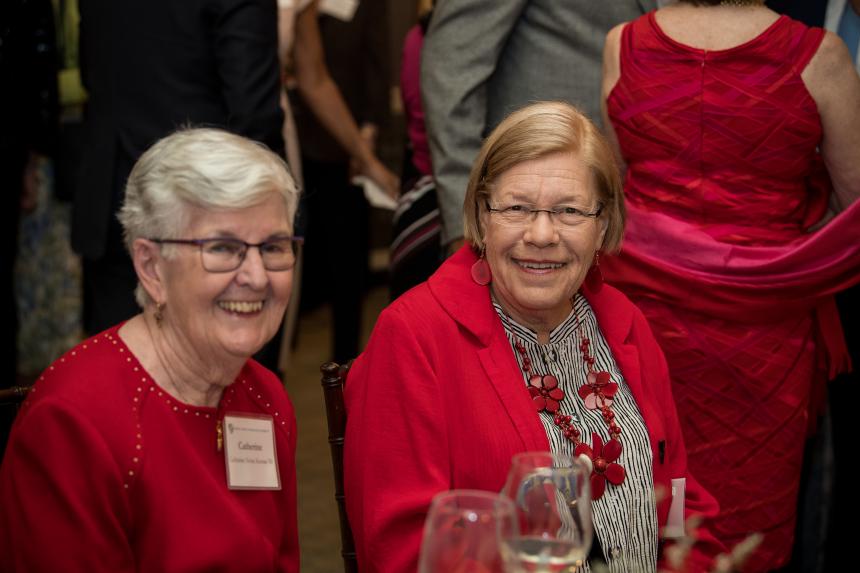 Two seated guests smile for the camera