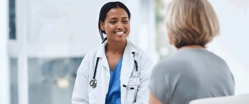 Physician assistant smiling and facing a patient