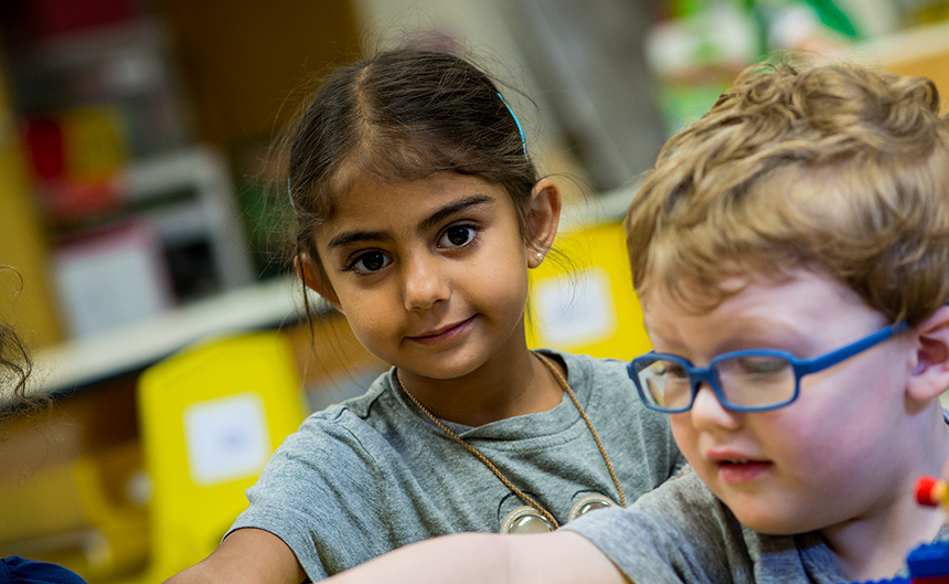 female and male preschoolers in a classroom