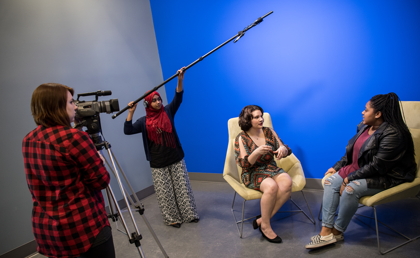 group of comm arts students filming an interview