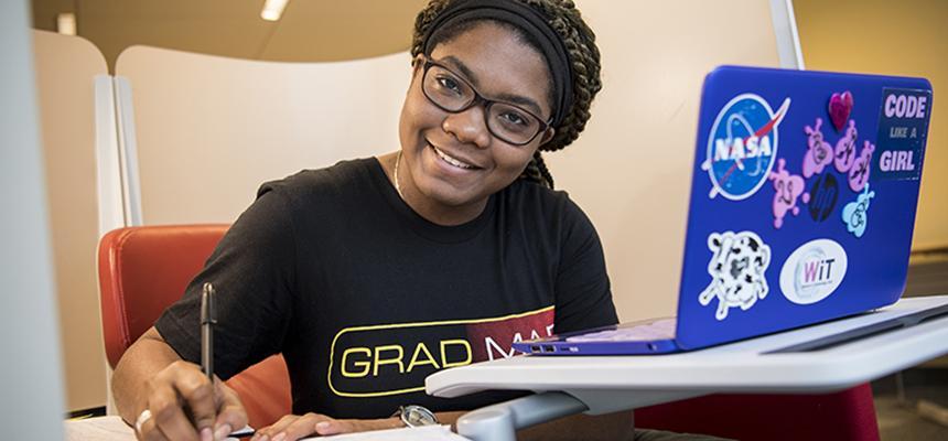 student sitting with laptop