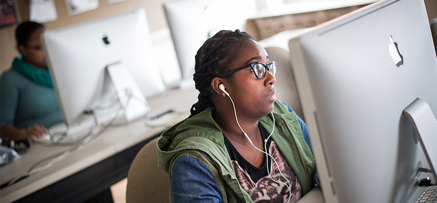 female student working on a mac