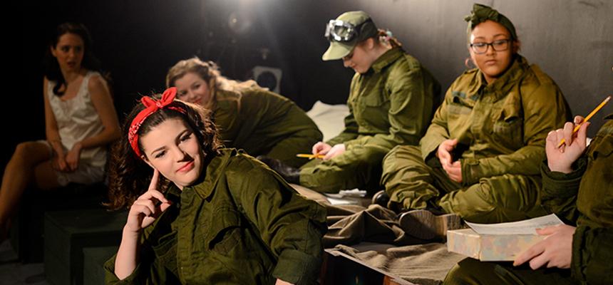 students in a play on stage