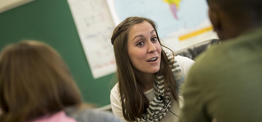 teacher helping student in class