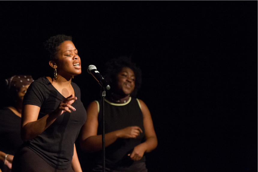 Performer singing into a microphone