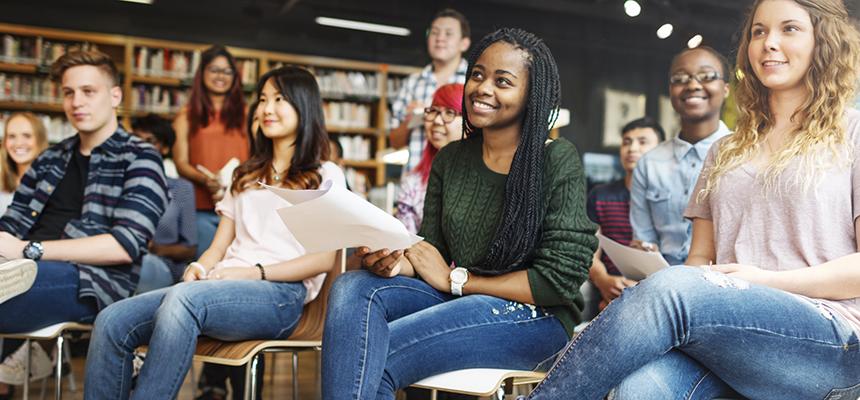 group of college students listening to instructor