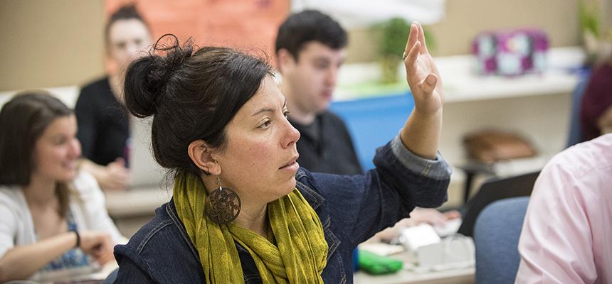 student raising her hand in class