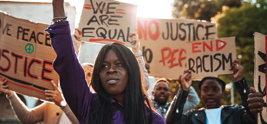 Group of protestors holding signs about racism and equality