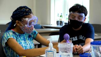 Girl and boy work together on a lab experiment